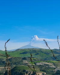 Scenic view of landscape against blue sky