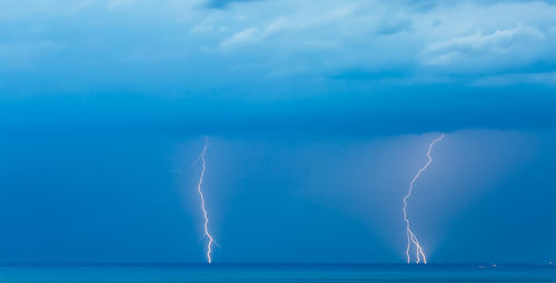 Lightning over sea against sky