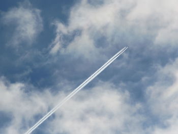 Low angle view of airplane flying against sky