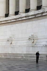 Rear view of woman walking on wall
