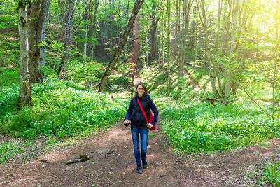 Rear view of man walking in forest