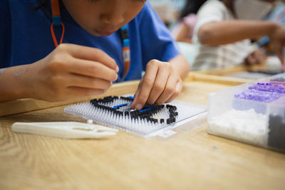 Close-up of girl doing activity at school