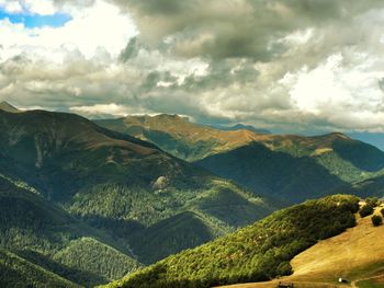 Scenic view of mountains against cloudy sky