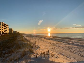 Scenic view of beach against sky during sunset