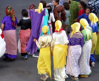 Rear view of people on multi colored umbrellas