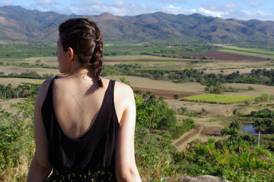 Rear view of young woman looking at mountains