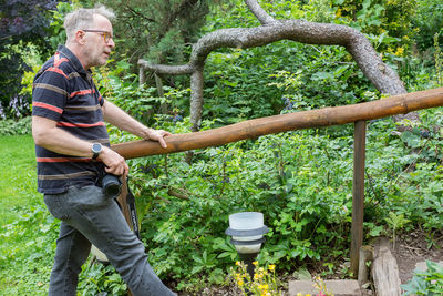 Side view of man working in forest