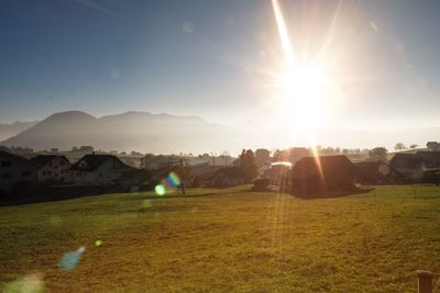 Houses in town against bright sun