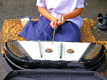 Girl playing music on street