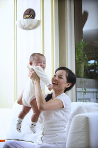 Happy mother and son on table