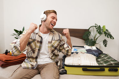 Portrait of senior couple sitting on sofa at home