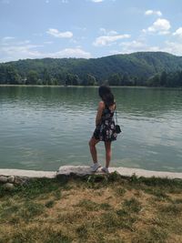 Full length of woman on lake against sky