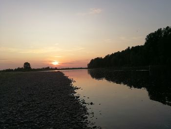 Scenic view of lake against sky during sunset