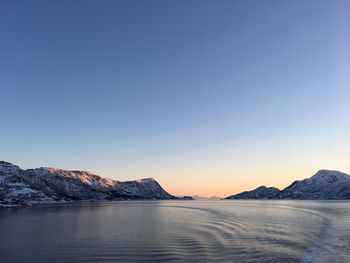 Scenic view of sea against clear sky during sunset