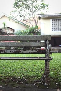 Bench in park by building
