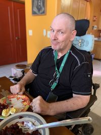 Midsection of man sitting at table