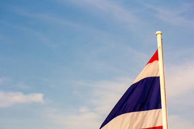 Low angle view of flag flags against sky