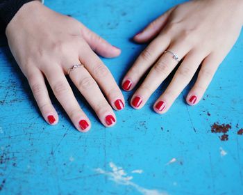 Cropped image of hands with red nail polish