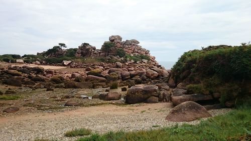 Rock formations on landscape against sky