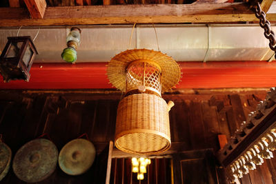 Low angle view of illuminated lanterns hanging on ceiling of store