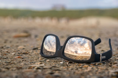 Close-up of sunglasses on field