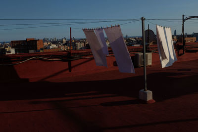 Clothes drying on clothesline against buildings in city