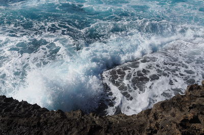 Waves splashing on rocks at shore