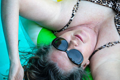 Close-up portrait of woman lying down