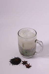 Close-up of beer glass against white background