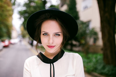 Portrait of young beatiful woman wearing black hat