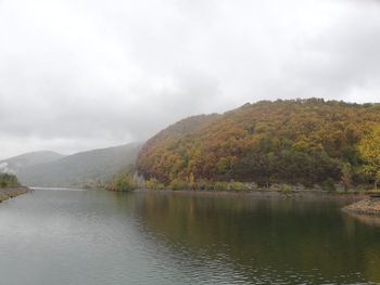 Scenic view of lake and mountains against sky