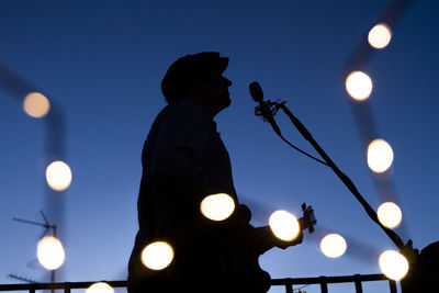 Low angle view of illuminated street light against sky at night