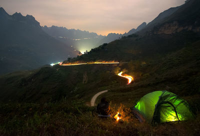 Aerial view of illuminated mountains against sky at night