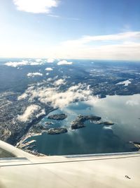 Aerial view of sea and mountains against sky