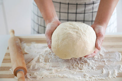 Woman holds dough in her hands and shows at camera. increasing price of wheat, flour and bread. 