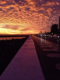 Road against cloudy sky at sunset