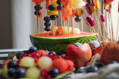 Colorful fruit dessert for a child's birthday. various shapes of fruit are put on toothpicks. 