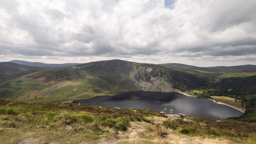 Scenic view of land and mountains against sky