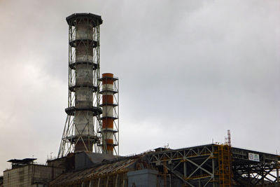 Low angle view of industrial building against sky