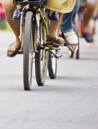 Low section of people riding bicycle on street