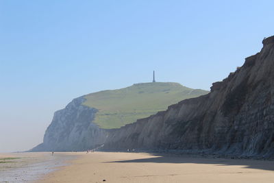 View of beach against clear blue sky