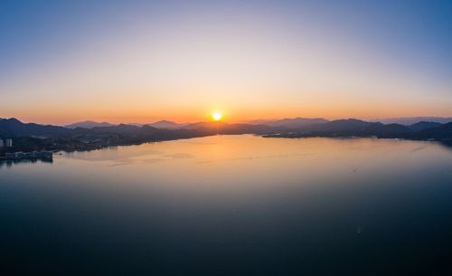 Scenic view of lake against sky during sunset