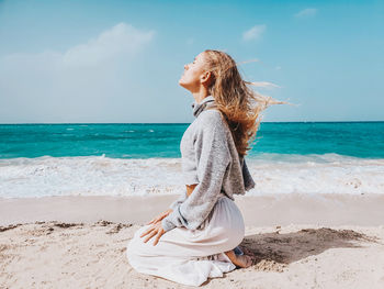 Full length of woman at beach against sky