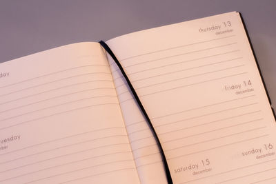 Close-up of open diary on table