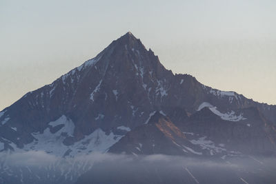 Scenic view of snowcapped mountains against clear sky