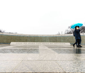 Full length of woman standing by railing