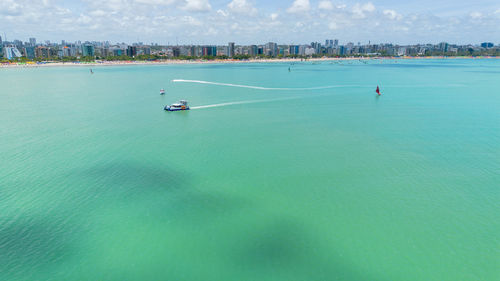 People kayaking in sea