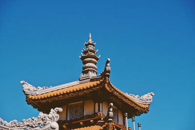 Low angle view of statue against blue sky