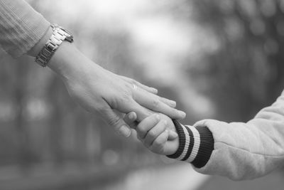 Cropped hands of mother and son