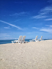 Scenic view of beach against blue sky